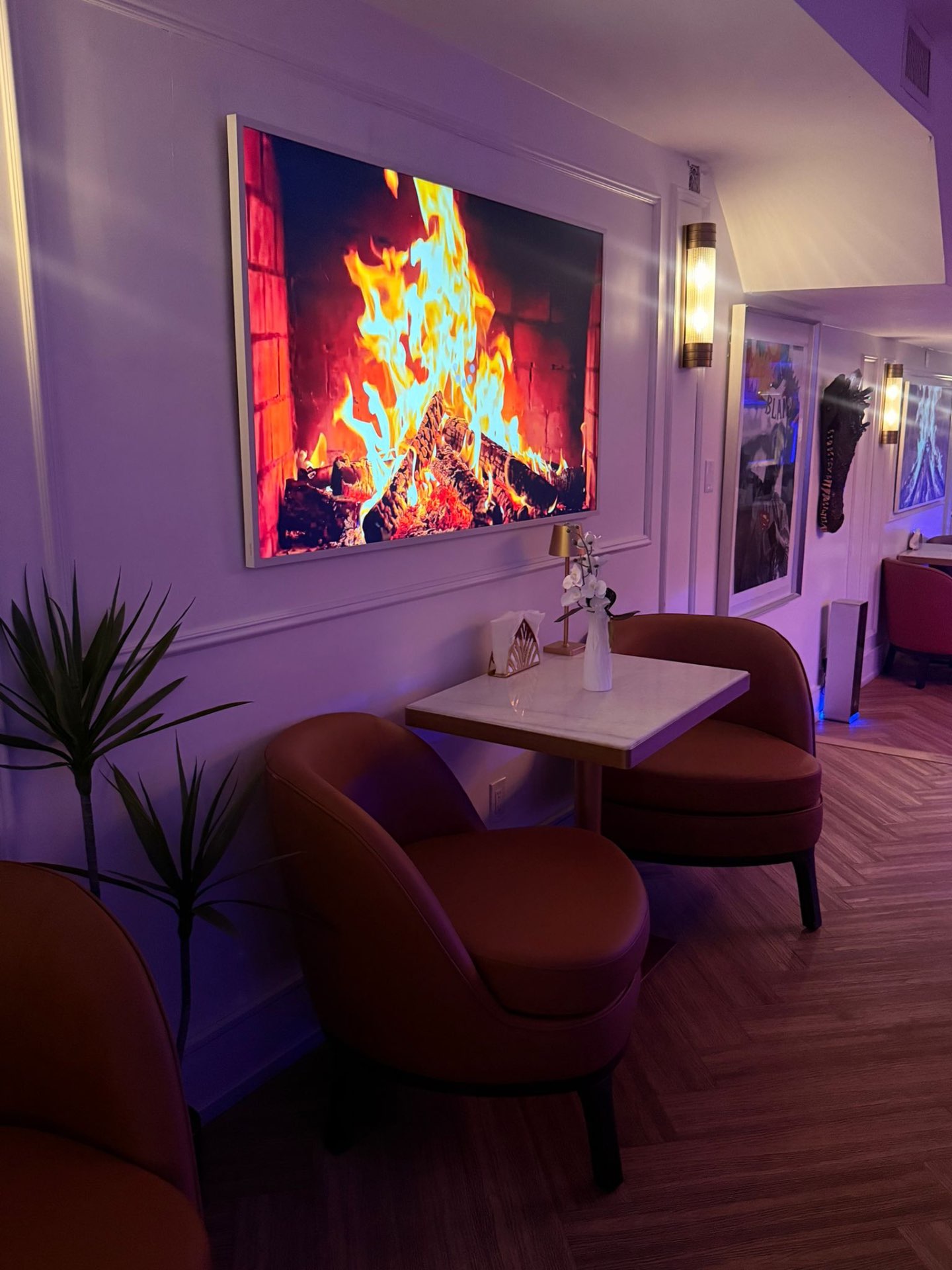 Fireside Nook — Tub Chairs by the Flames Intimate fireplace nook with tan tub chairs and marble table at Yorkville Lounge