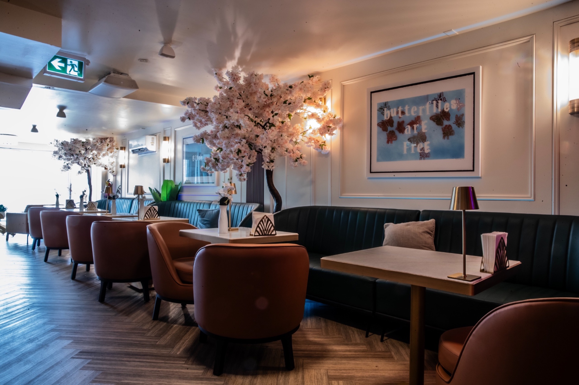 Banquettes — Blossom Canopy Seating Banquette seating beneath blossom canopy at Yorkville Lounge