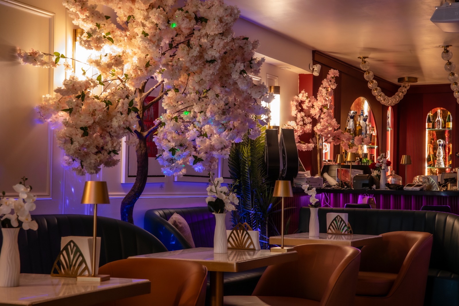 Cherry blossom canopy over banquettes at Yorkville Lounge
