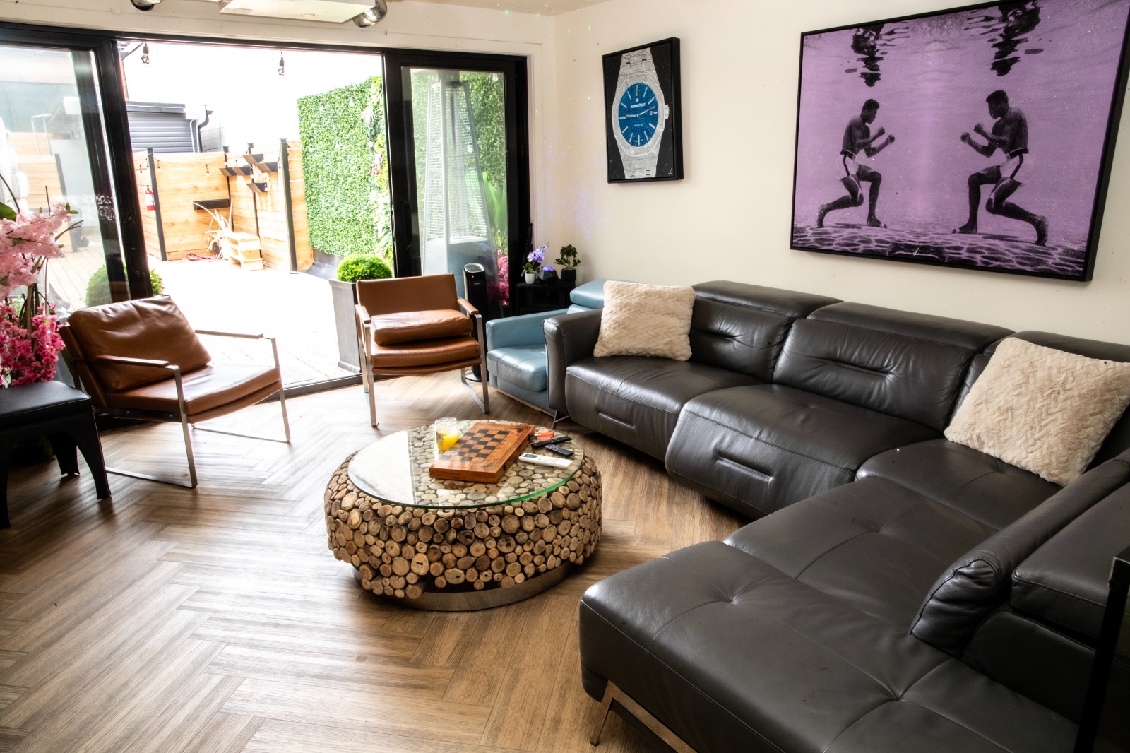 Lounge interior with leather sectional and pop-art prints